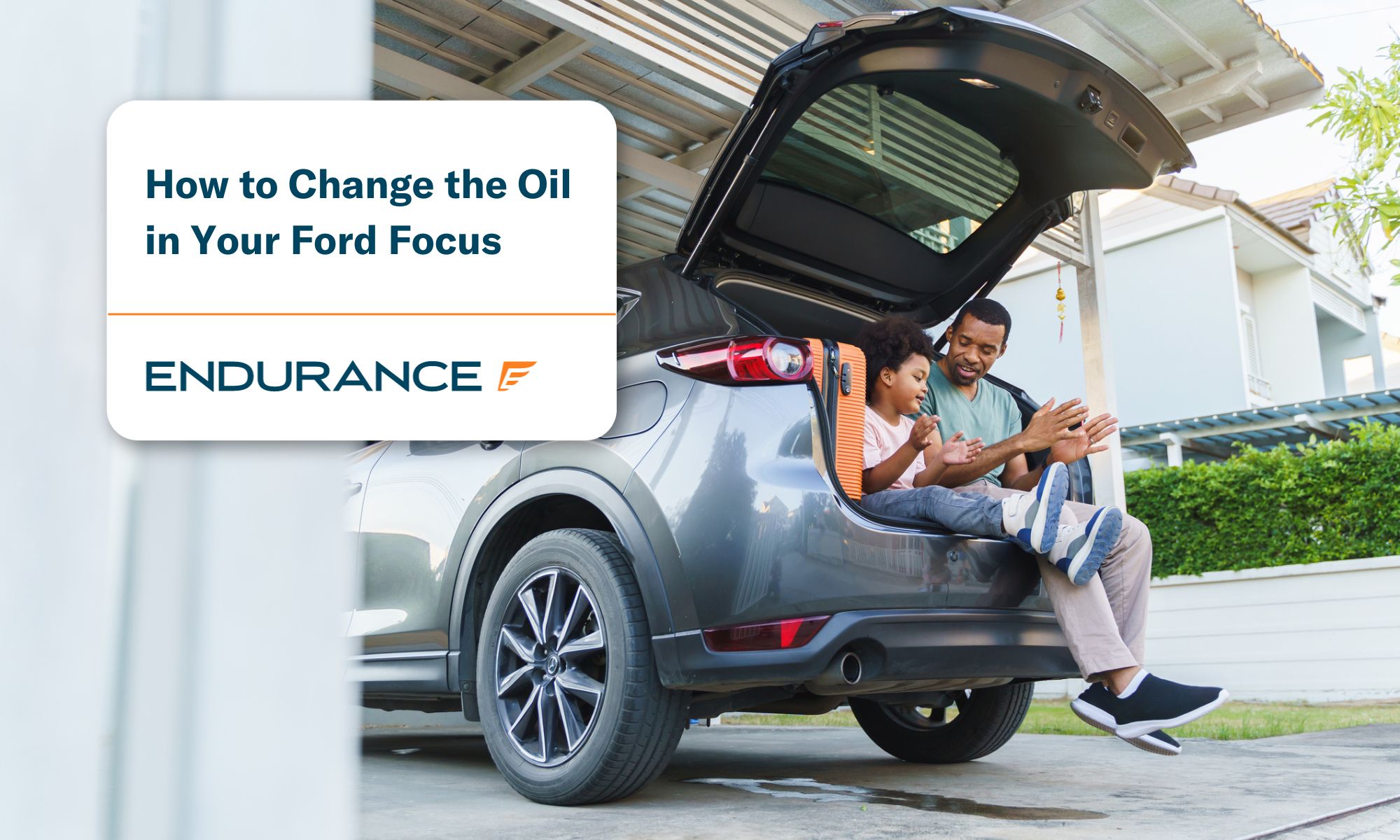 Father and Son sitting in the back of a Ford Focus hatchback