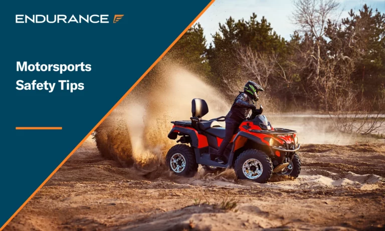 A young man racing an ATV off-road while wearing a helmet and other safety equipment.