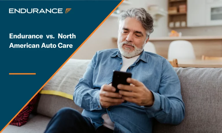 Man with a white beard sitting on his couch and using his mobile phone