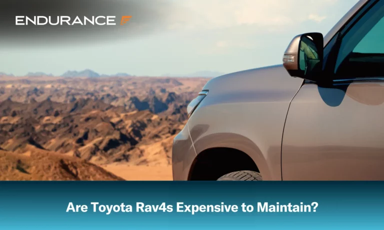 Close-up of a Toyota vehicle in the sand before a cliff