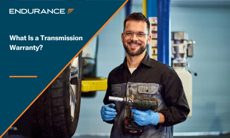 A smiling mechanic working in the repair shop service, holding a drill