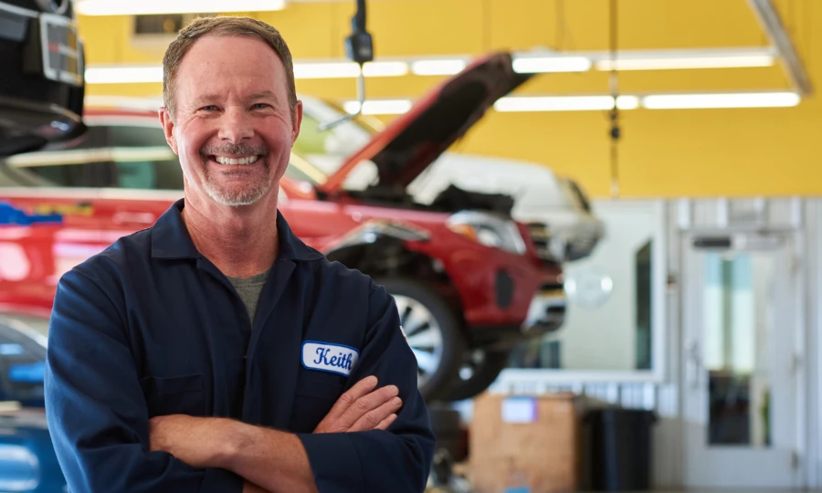 ASE Certified mechanic Keith Benline smiling in a repair shop